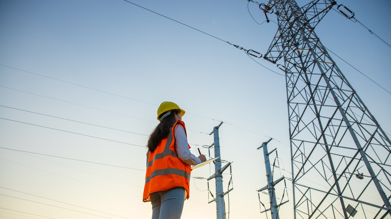 Electrical engineer working near storage tower