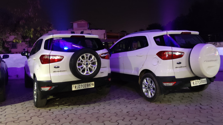 Two white Ford EcoSports parked side-by-side in a parking lot.