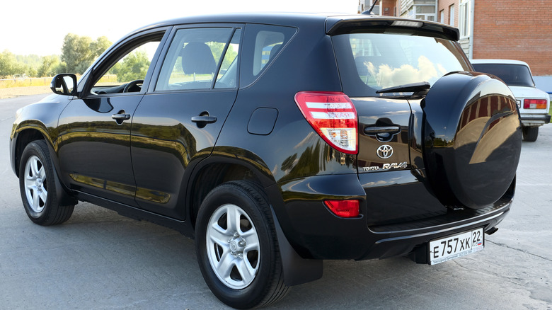 A black 2012 Toyota RAV4 photographed from the back