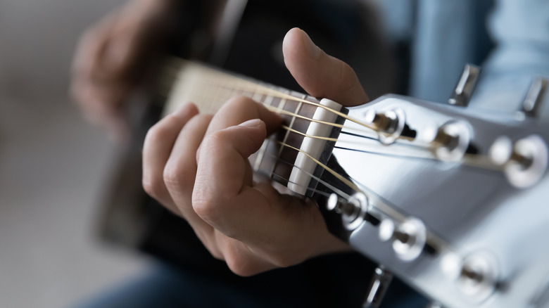 Hands playing guitar