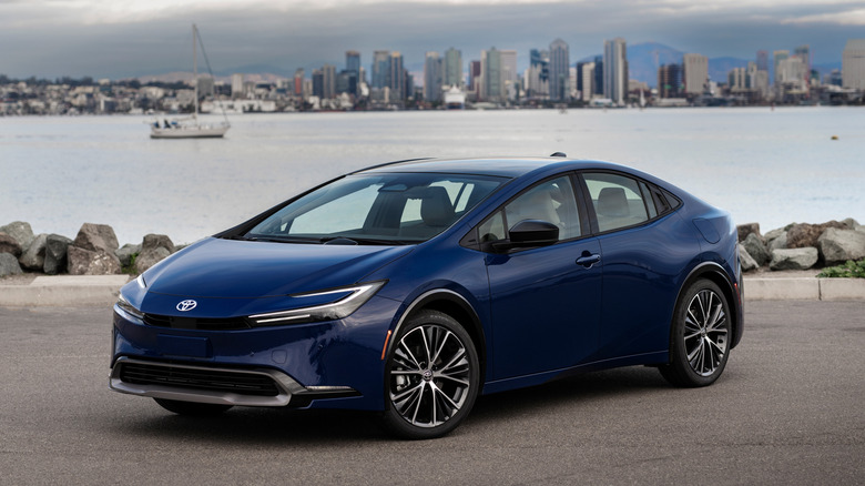 A 2025 Toyota Prius in dark blue at a port, front 3/4 view