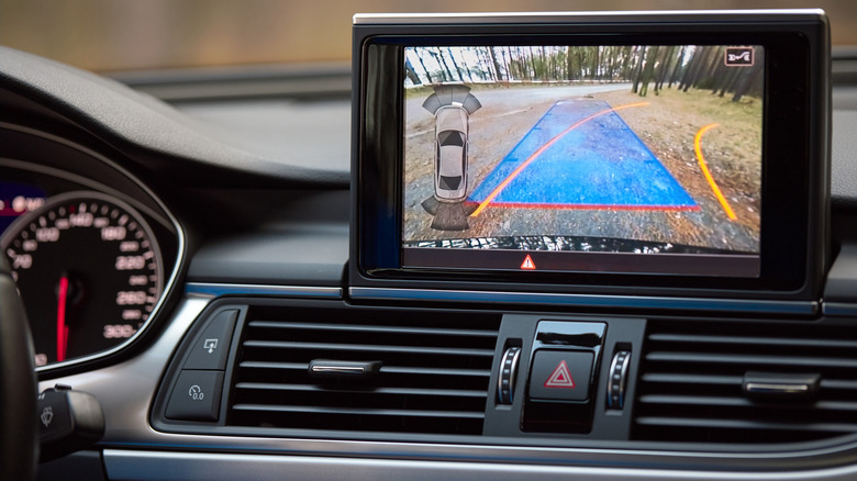 A car backup camera's view displayed on a dashboard monitor.