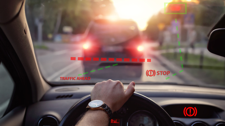 A car with forward collision warning displayed on its windshield.