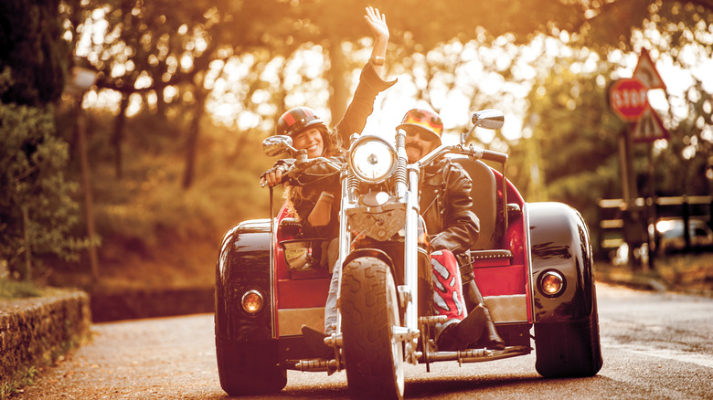 Happy couple on a trike motorcycle