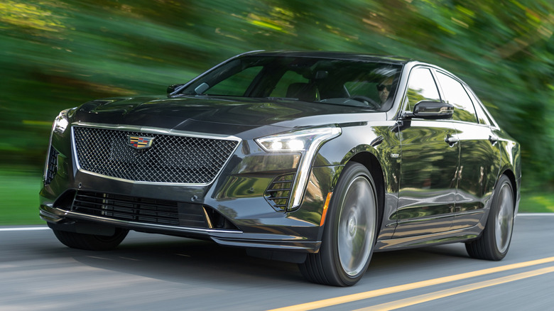 black 2019 Cadillac CT6-V driving on tree-lined road