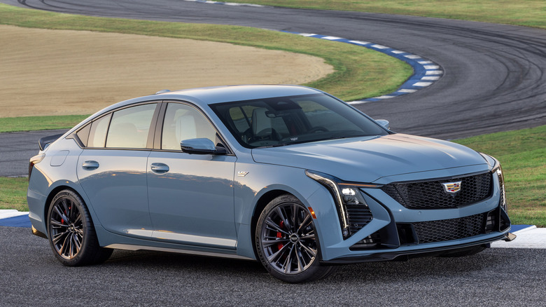 blue-grey Cadillac Blackwing CT5-V driving on racetrack