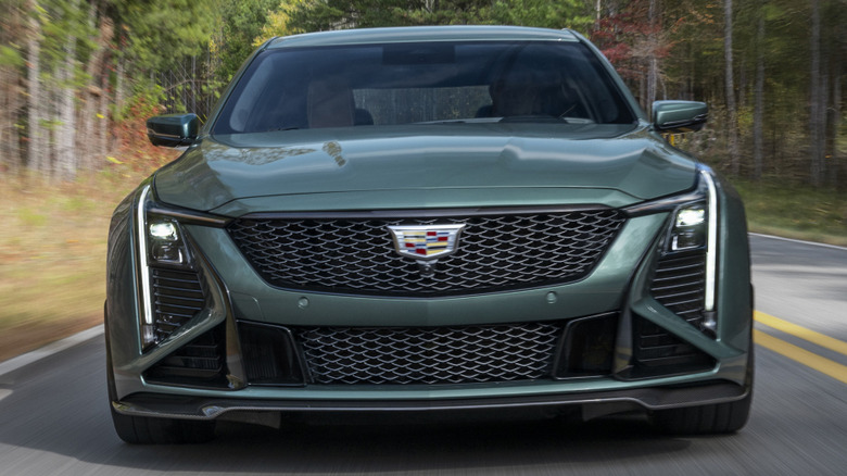 Green Cadillac CT5 Blackwing on tree-lined road