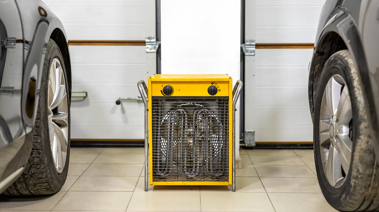 Yellow garage heater between two cars