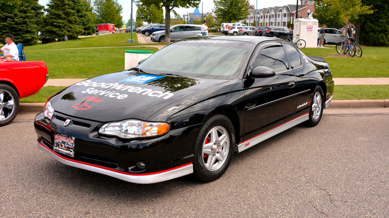 A sixth generation Chevrolet Monte Carlo with a Goodwrench Service decal, front 3/4 view, black exterior