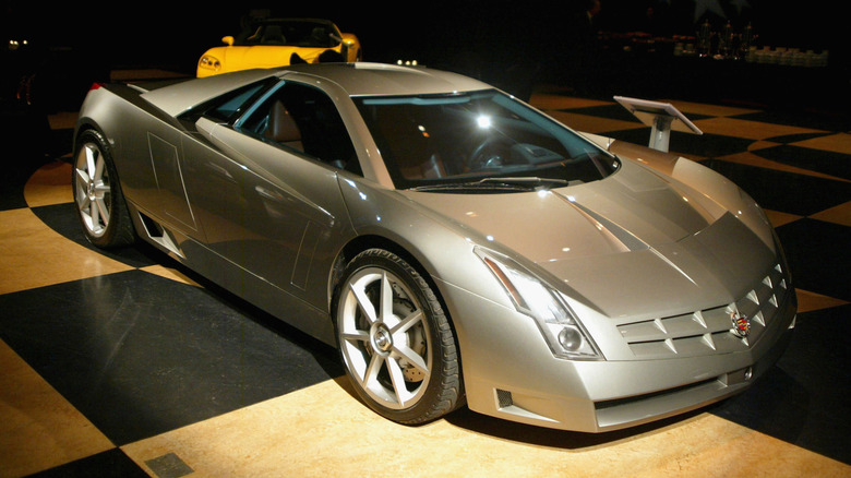 A Cadillac Cien at a car show, harsh lighting, front 3/4 view, silver exterior