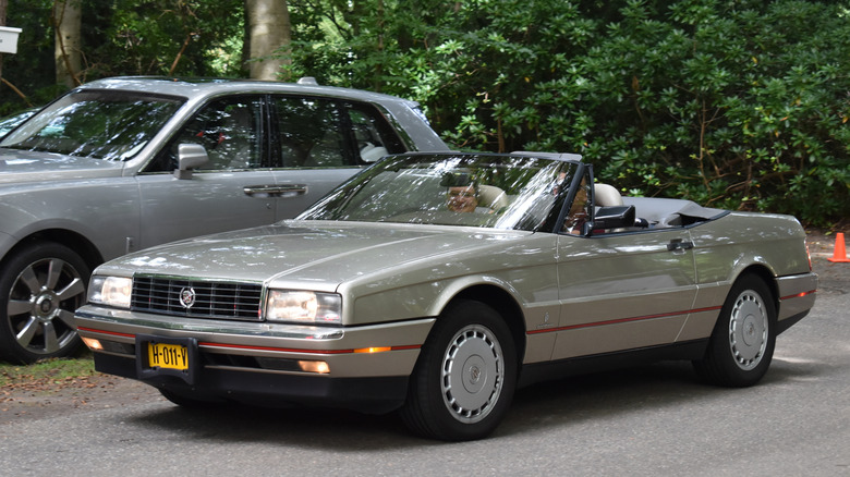 A bronze Cadillac Allante on the move, front 3/4 view, roof down