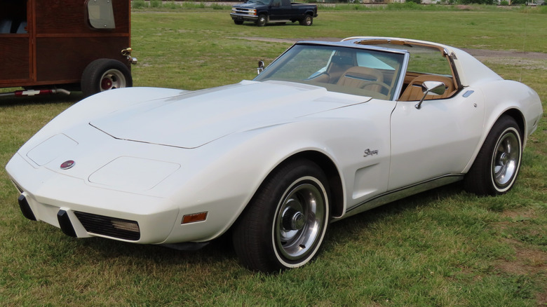 White 1975 Corvette parked in grass