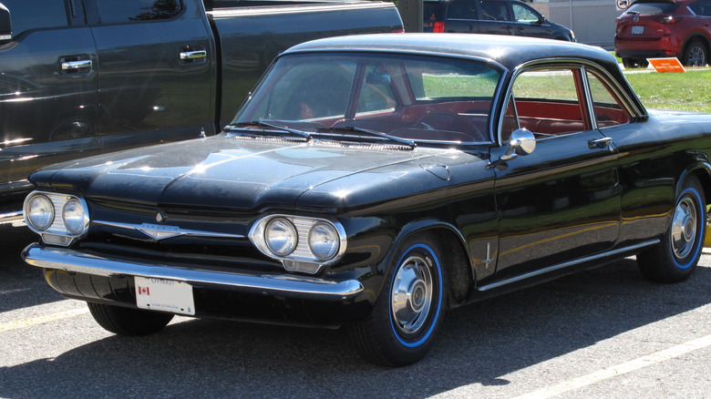 black 1961 Chevy Corvair parked on pavement