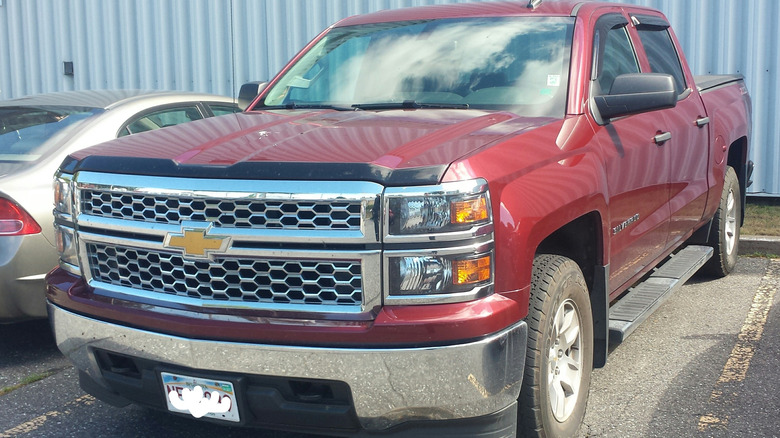 Red Chevrolet Silverado 1500 double cab parked in lot