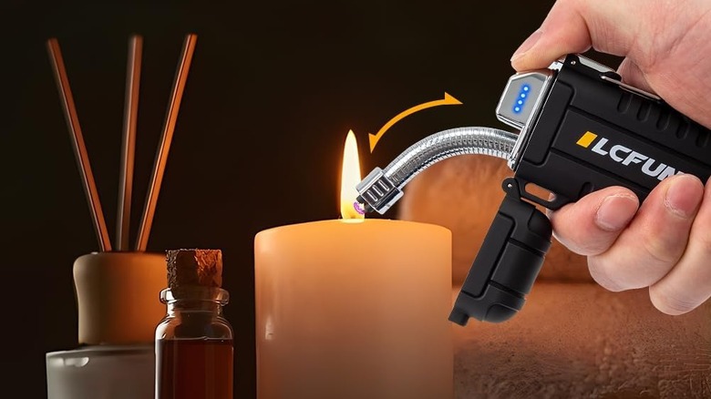 person using lighter to light candle