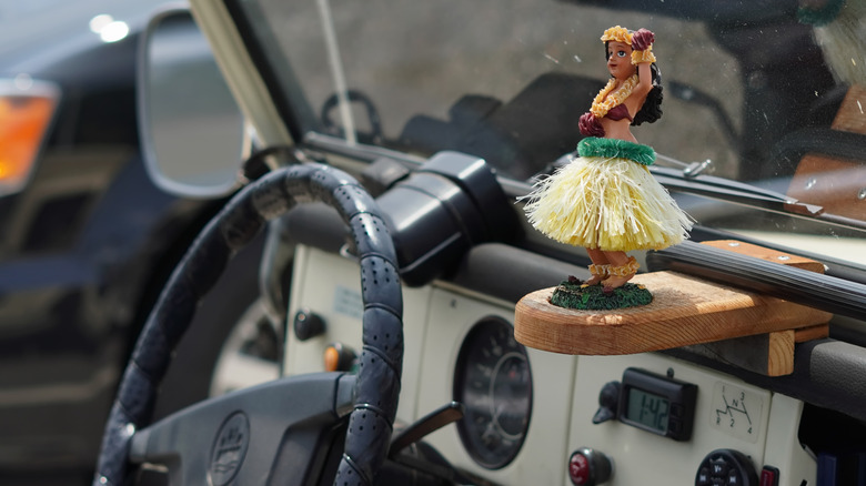 Hula dancer ornament on a car dashboard