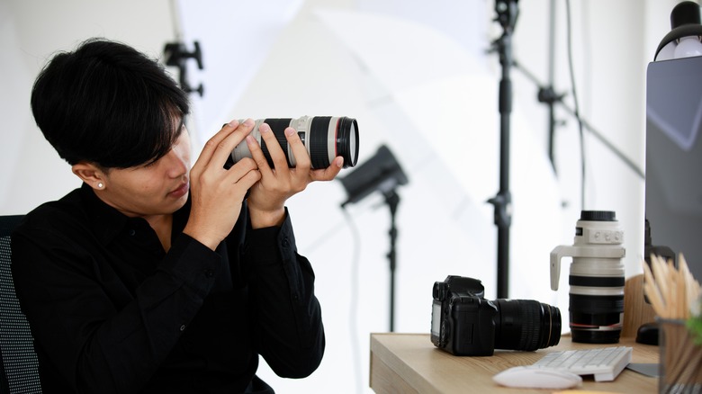 Photographer inspecting a lense