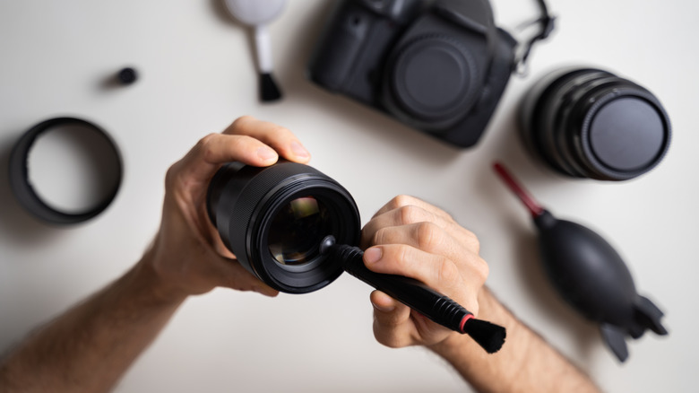 Photographer using a lens pen