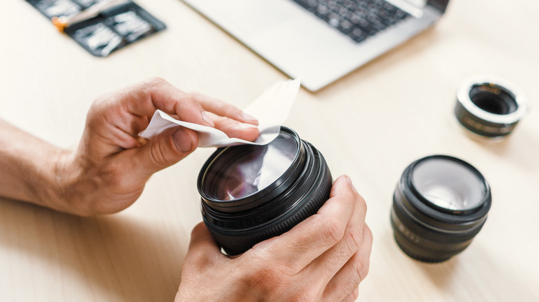 Photographer using a lens tissue