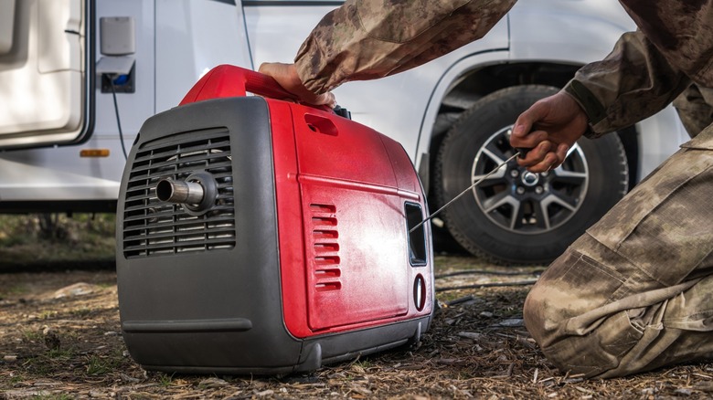 Man turning on generator for RV