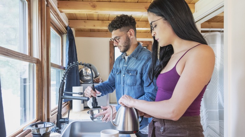 Two people in an RV kitchen