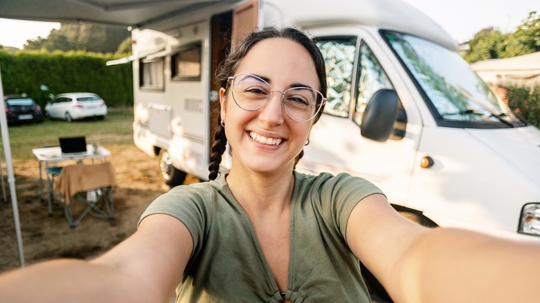 Woman smiling in front of RV