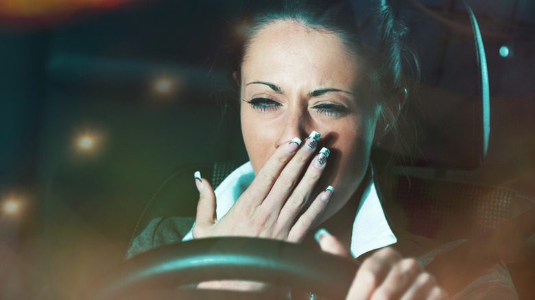 Woman yawning while driving