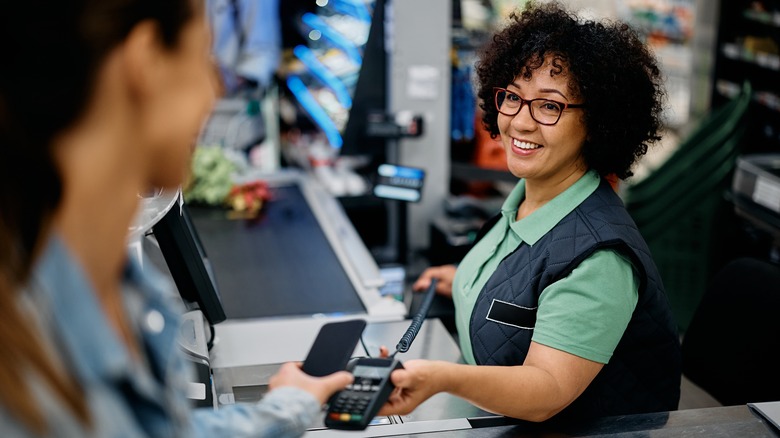 woman paying for groceries