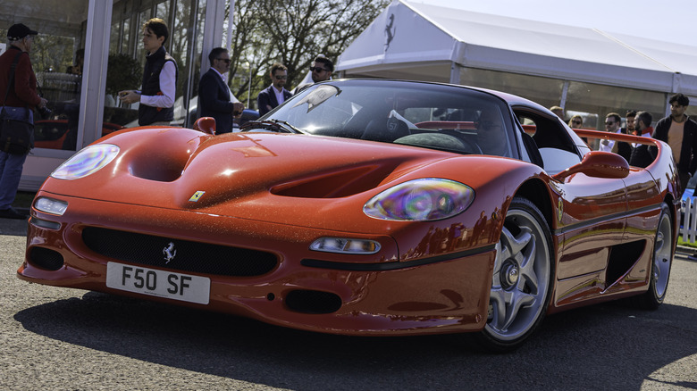 A red Ferrari F50 at a car show.