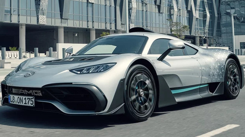 A Mercedes AMG-One on a street outside a building.