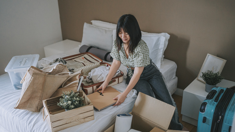 young woman decluttering room