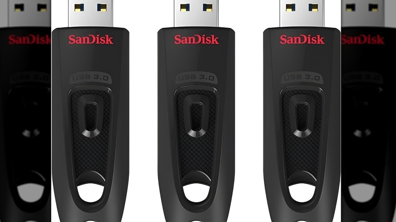 Three flash drives on white background