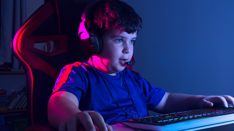 young boy gaming with headset