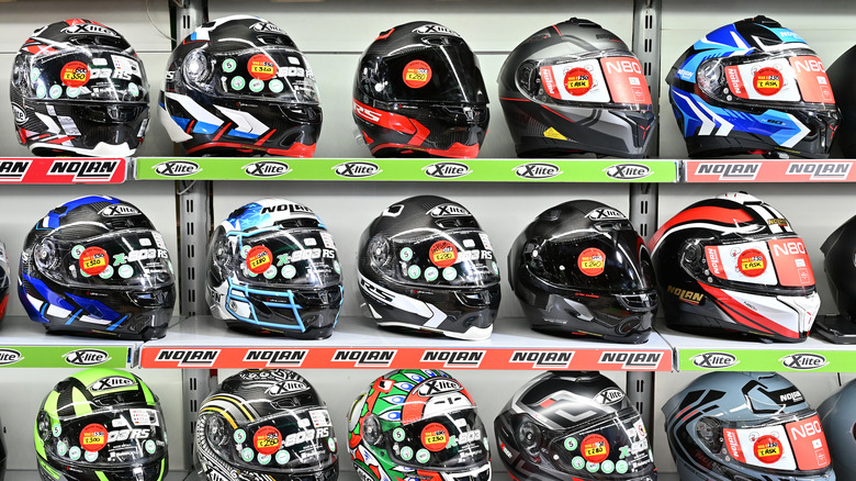 Colorful motorcycle helmets on shelves