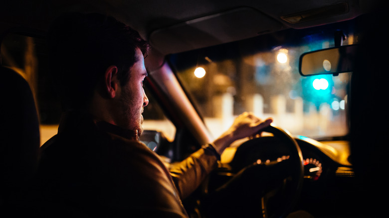 Man watching road while driving at night