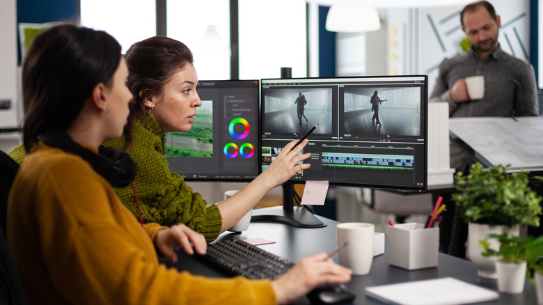 Two editors reviewing footage on computer