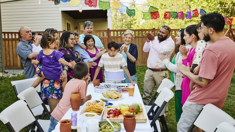 family celebrating birthday in backyard