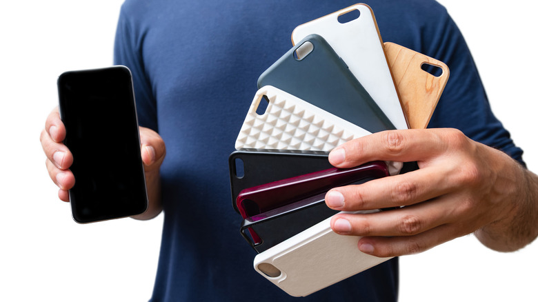 Man holding old phone cases