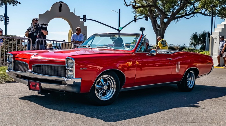 Red Pontiac LeMans convertible at an outdoor event