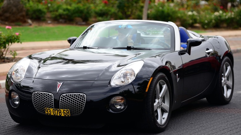 Pontiac Solstice convertible cruising on a paved road