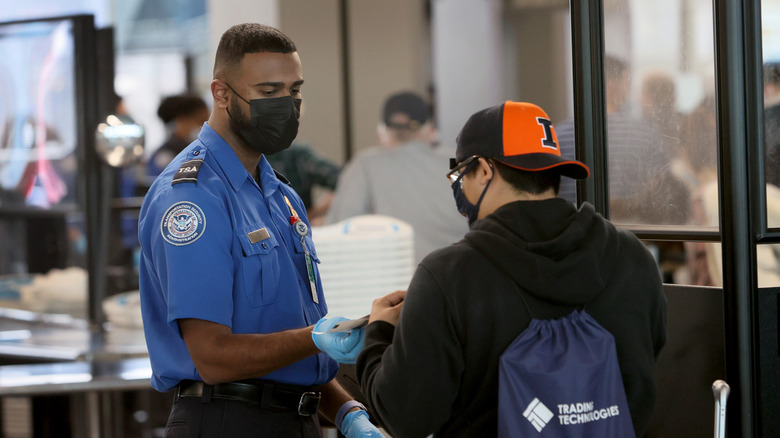 A TSA officer screens passengers at O'Hare Airport