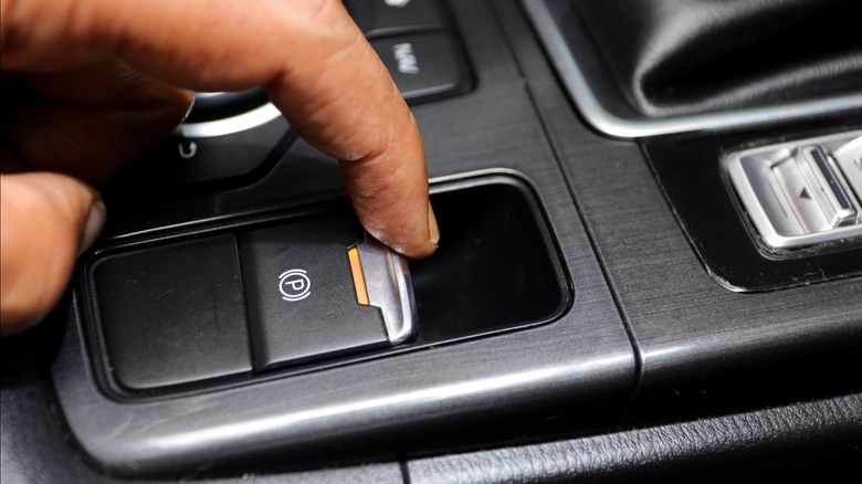 Driver pushing buttons in a car