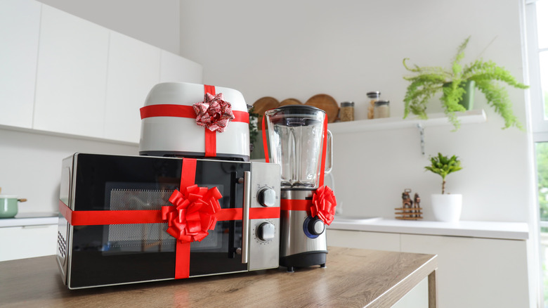 Microwave, blender, and toaster wrapped in a red ribbon