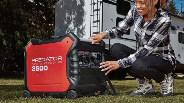 A woman connecting to a portable Predator power generator outside her RV.