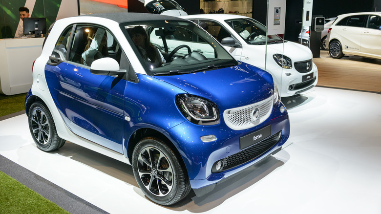 The third generation Smart Fortwo at an auto show, blue and white exterior, front 3/4 view