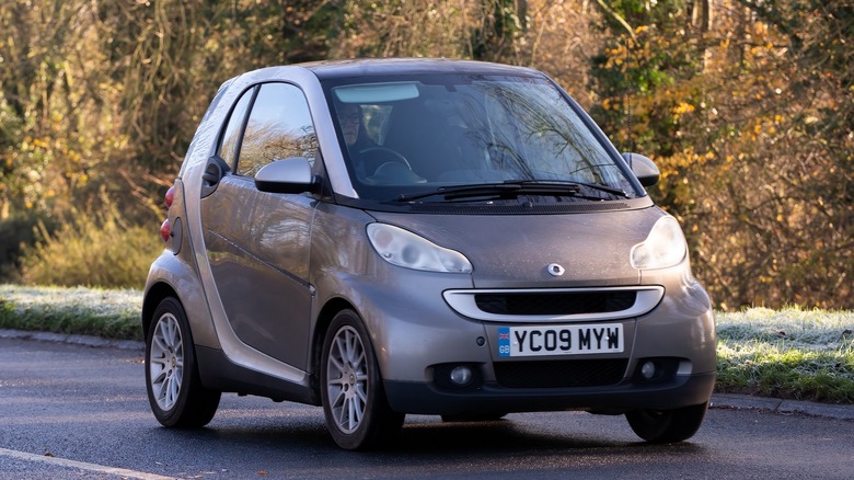 A bronze Smart Fortwo on the move, front 3/4 view