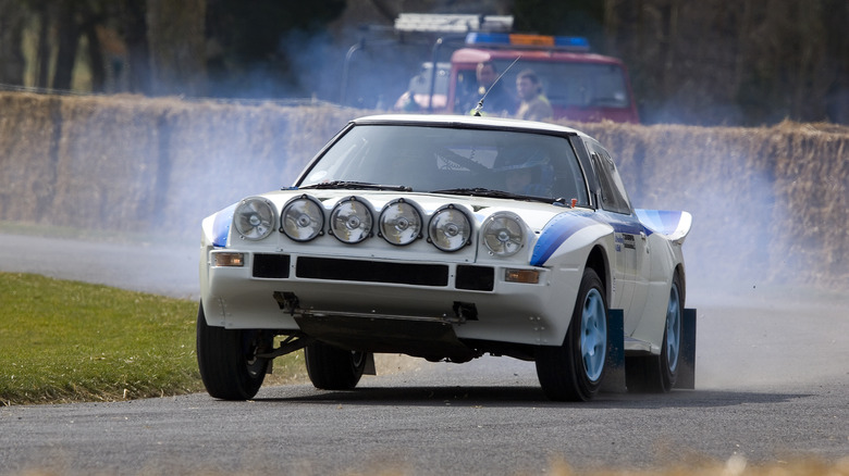 The Group B Mazda RX-7 going up the Goodwood Hillclimb, front 3/4 view