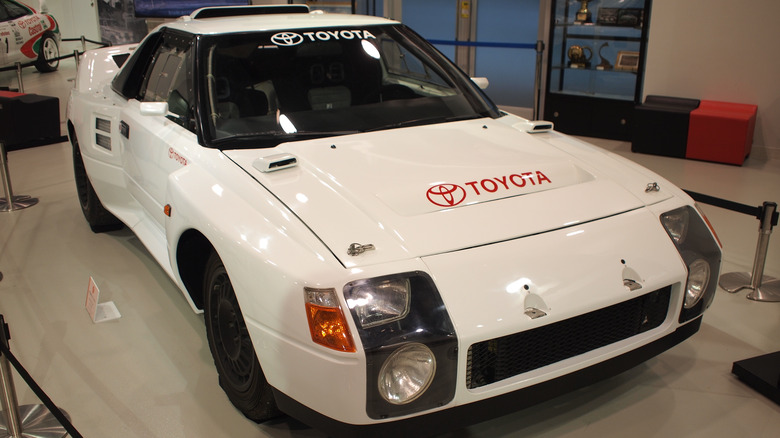 The Toyota 222D in white on display at a museum, front 3/4 view