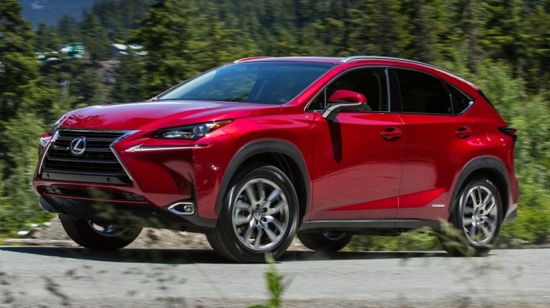 Lexus NX 300h parked with trees and mountains in the background