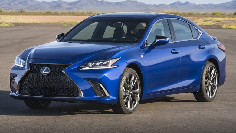 Lexus ES parked on a pavement with mountains in the background